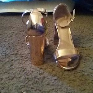 Shiny rose gold ankle heels.